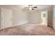 Spacious bedroom with neutral carpeting and access to a private bathroom at 1123 Redan Way, Stone Mountain, GA 30088