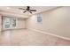 Spacious basement features tile flooring, French doors, and ceiling fan at 1123 Redan Way, Stone Mountain, GA 30088