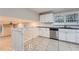 Open kitchen with white cabinets, granite counters, and a view of the living area at 1123 Redan Way, Stone Mountain, GA 30088