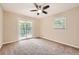 Bright bedroom with a ceiling fan and sliding glass doors to balcony at 1123 Redan Way, Stone Mountain, GA 30088