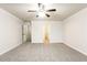 Bright bedroom with carpet flooring, ceiling fan and access to hallway and bathroom at 6393 Shadow Sq, Lithonia, GA 30058