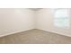 Simple bedroom with carpet flooring and a window at 6393 Shadow Sq, Lithonia, GA 30058