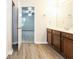 Bathroom with wood cabinets, a double vanity and a view of a bedroom at 6393 Shadow Sq, Lithonia, GA 30058