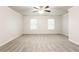 Spacious bedroom with carpet flooring and two windows at 6393 Shadow Sq, Lithonia, GA 30058