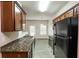 Modern kitchen with granite countertops, stainless steel appliances, and ample cabinet space at 6393 Shadow Sq, Lithonia, GA 30058