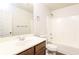 Clean bathroom with a shower/tub combo, toilet and vanity with wood cabinets at 6393 Shadow Sq, Lithonia, GA 30058