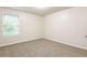 Simple bedroom with neutral wall paint, carpet flooring, and a window with blinds at 6393 Shadow Sq, Lithonia, GA 30058