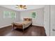 Cozy bedroom featuring hardwood floors, a ceiling fan, and ample natural light at 1520 Oxford St, Douglasville, GA 30134