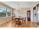 Charming dining room with hardwood floors, floral wallpaper, and a round table at 3216 Guynelle Dr, Marietta, GA 30066