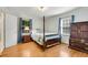 Cozy bedroom with hardwood floors, blue bedding, and a wooden bed frame at 3216 Guynelle Dr, Marietta, GA 30066