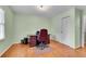 Home office with light green walls, hardwood floors, and built-in desk and shelving at 3216 Guynelle Dr, Marietta, GA 30066