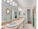 Bright bathroom with double sinks, a large mirror, and light green walls at 3216 Guynelle Dr, Marietta, GA 30066
