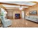 Bright living room featuring hardwood floors, built-in shelving, and a large TV at 3216 Guynelle Dr, Marietta, GA 30066