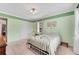 Charming bedroom with light green walls, carpeted floors, and a white metal bed frame at 3216 Guynelle Dr, Marietta, GA 30066