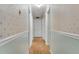Long hallway with light green and white walls, hardwood floors, and multiple doors at 3216 Guynelle Dr, Marietta, GA 30066