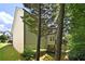 Back exterior of house showcasing a large deck and private wooded area at 230 Ridge Bluff Ln, Suwanee, GA 30024