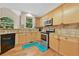 Kitchen with granite countertops, stainless steel appliances, and light wood cabinets at 230 Ridge Bluff Ln, Suwanee, GA 30024