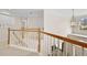 Upstairs hallway with wood railing and neutral carpeting at 230 Ridge Bluff Ln, Suwanee, GA 30024