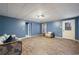 Finished basement living area with a sofa, chair, and access to a patio at 403 Pebblebrooke Ln, Canton, GA 30115