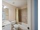 Clean bathroom with a shower/tub combo, tile surround, and white vanity at 403 Pebblebrooke Ln, Canton, GA 30115