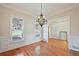 Formal dining room with hardwood floors and elegant chandelier at 403 Pebblebrooke Ln, Canton, GA 30115