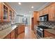Eat-in kitchen with granite countertops, stainless steel appliances, and ample cabinetry at 403 Pebblebrooke Ln, Canton, GA 30115
