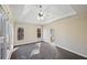 Spacious main bedroom with trey ceiling, carpeting, and large windows at 403 Pebblebrooke Ln, Canton, GA 30115