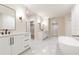 Modern bathroom with double vanities, a soaking tub and marble floors at 6175 River Shore Pkwy, Atlanta, GA 30328