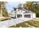 White brick house with a large driveway and attached garage at 6175 River Shore Pkwy, Atlanta, GA 30328