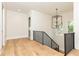 Upstairs hall with hardwood floors, a modern railing, and a chandelier at 6175 River Shore Pkwy, Atlanta, GA 30328