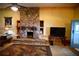 Rustic stone fireplace is a focal point, with built-in shelving and a large mantle at 1625 Brushy Mountain Rd, Rockmart, GA 30153