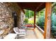 Relaxing stone porch with rocking chairs and wooded views at 1625 Brushy Mountain Rd, Rockmart, GA 30153