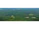 Aerial view of a property showcasing a house and expansive wooded acreage at 1625 Brushy Mountain Rd, Rockmart, GA 30153