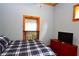 Charming bedroom with plaid bedding and a dresser at 1625 Brushy Mountain Rd, Rockmart, GA 30153