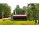 Rustic cabin with red metal roof and screened porch at 1625 Brushy Mountain Rd, Rockmart, GA 30153