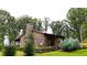 Rustic stone house with a covered porch nestled in the woods at 1625 Brushy Mountain Rd, Rockmart, GA 30153