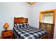 Comfortable bedroom with plaid bedding and antique wooden headboard at 1625 Brushy Mountain Rd, Rockmart, GA 30153