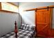 Charming bedroom with a wooden barn door and a comfortable bed at 1625 Brushy Mountain Rd, Rockmart, GA 30153