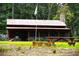 Rustic cabin with metal roof, picnic table, and stone chimney at 1625 Brushy Mountain Rd, Rockmart, GA 30153
