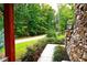 Walkway leading to home with stonework and landscaping at 1625 Brushy Mountain Rd, Rockmart, GA 30153
