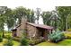 Rustic stone house with a covered porch and beautiful landscaping at 1625 Brushy Mountain Rd, Rockmart, GA 30153