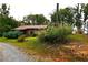Rustic stone and metal cabin with a large grassy yard and flag at 1625 Brushy Mountain Rd, Rockmart, GA 30153