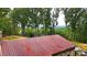 Aerial view of a rustic stone house with a metal roof and mountain views at 1625 Brushy Mountain Rd, Rockmart, GA 30153