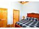 Spacious bedroom with wooden floors and doors, and a comfortable bed at 1625 Brushy Mountain Rd, Rockmart, GA 30153