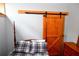 Cozy bedroom featuring a wooden barn door and a comfortable bed at 1625 Brushy Mountain Rd, Rockmart, GA 30153