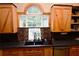Kitchen features a farmhouse sink and arched window overlooking backyard at 1625 Brushy Mountain Rd, Rockmart, GA 30153