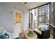 Relaxing screened porch with wicker furniture and a view of the courtyard at 58 Peachtree Memorial Nw Dr # 1, Atlanta, GA 30309