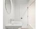 Simple bathroom with white vanity, round mirror, and white subway tile at 58 Peachtree Memorial Nw Dr # 1, Atlanta, GA 30309