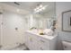 Elegant bathroom featuring a white vanity, a large mirror, and a walk-in shower at 58 Peachtree Memorial Nw Dr # 1, Atlanta, GA 30309