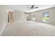 Spacious living room with neutral carpet, large windows, and a view of the backyard at 1870 Rocksram Dr, Buford, GA 30519
